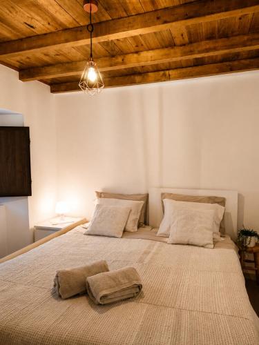 a bedroom with a large bed with two pillows on it at Casa dos Laia in Sobreira Formosa