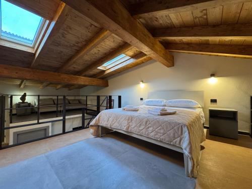 a bedroom with a large bed in a room with wooden ceilings at Atelier Volturno in La Maddalena
