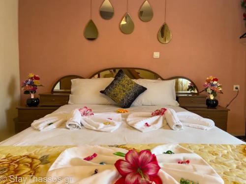 a bedroom with a bed with towels on it at Apartment Lampiri in Limenaria