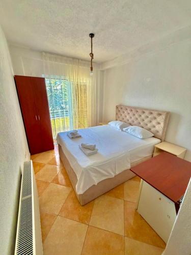 a bedroom with a large bed and a table at Vala Rooms in Struga