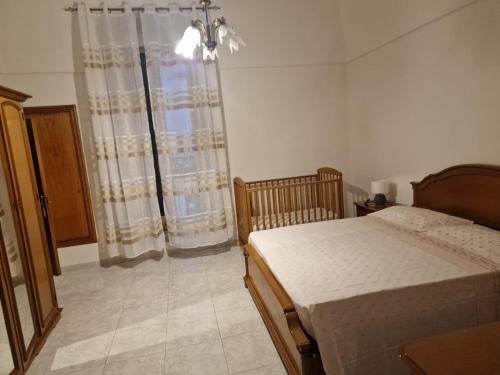a bedroom with a bed and a window at Frangio' in Noci