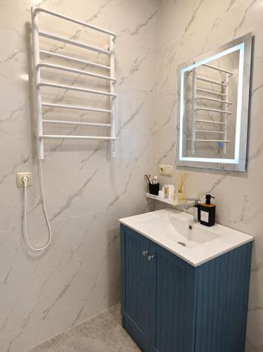 a bathroom with a sink and a mirror at Trio Villas Retreat in Grigoleti