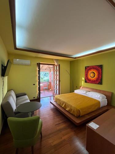 a bedroom with a bed and a table and a couch at Da Francesca guestrooms in Patrica