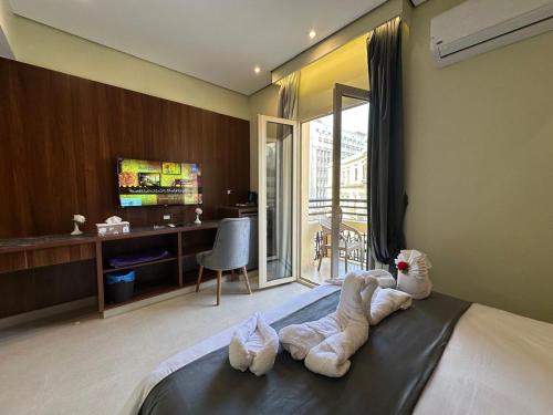 a room with a bed with towels on it at Sama Hotel Oraby in Cairo