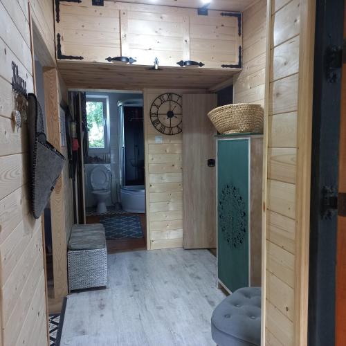 a bathroom with a toilet and a clock on the wall at Jeziorskie Zacisze & balia in Łyszkowice