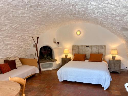 a bedroom with two beds and a fireplace at La Petite Bergerie in Éze