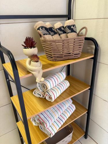 a shelf with towels and a basket on it at Apartmani Primorski kutak in Jadranovo