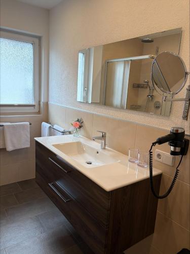a bathroom with a sink and a mirror at ONO Apartments in Längenfeld