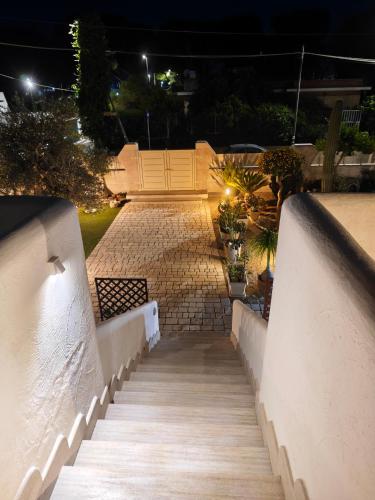a stairway leading up to a building at night at The Lux Beach Apartments in Specchiolla