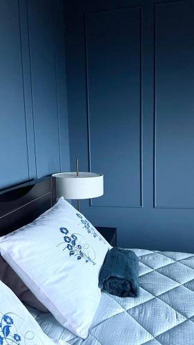 a bedroom with a bed with a blue wall at Apartment Sunrise in Kunjići