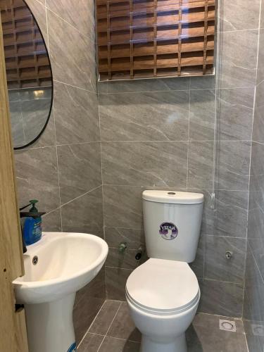a bathroom with a toilet and a sink at Modern 2 BR apartment in Lekki