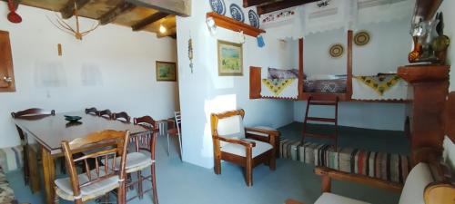 a small room with a table and chairs and a room with a table and chairs at Tinas House in Afiartis
