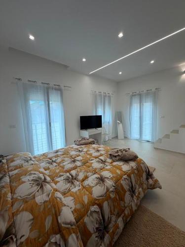 a bedroom with a large bed in a room with windows at Al58 Casa Vacanze in Villasmundo