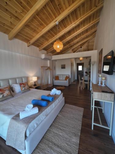 a bedroom with a large bed with blue pillows at Lovely Sea View Apartments & Junior Suites in Himare