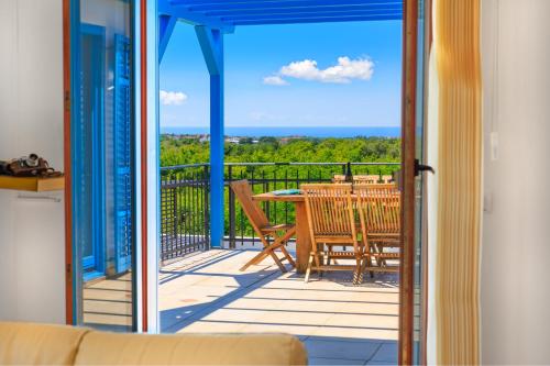 a view of a balcony with a table and chairs at Villa Umag Istria seaview private pool and garage by Rentistra in Umag