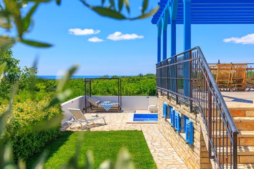 a patio with a view of the ocean from a house at Villa Umag Istria seaview private pool and garage by Rentistra in Umag
