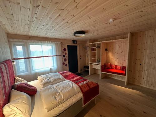 a bedroom with a bed and a couch in it at Kulturgården Bjerkem in Steinkjer