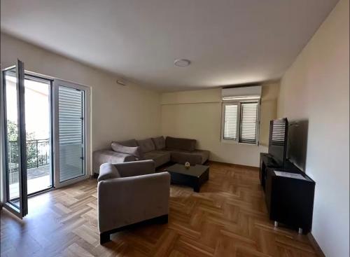 a living room with a couch and a tv at Cozy&Spacious in Kotor