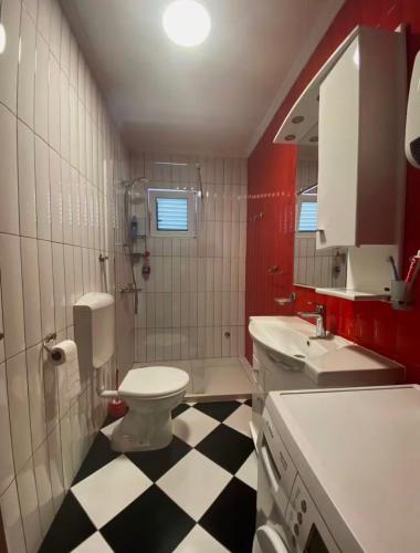 a bathroom with a black and white checkered floor at Cozy&Spacious in Kotor
