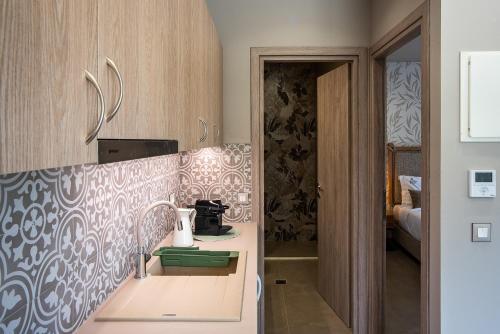 a kitchen with a counter with a sink at Ivy Residences with Pool in Ayía Varvára