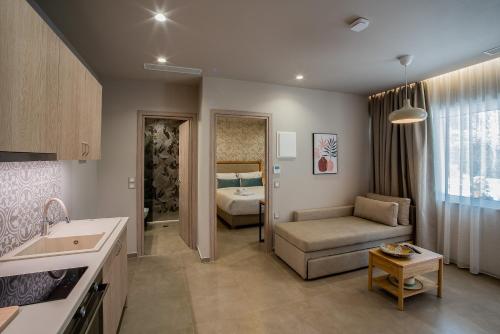 a kitchen and living room with a couch and a bed at Ivy Residences with Pool in Ayía Varvára
