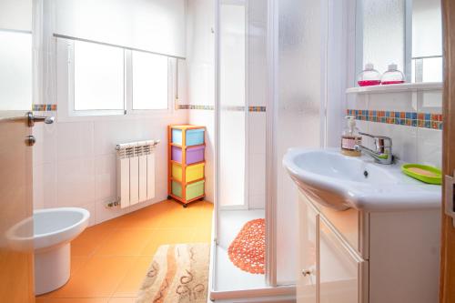 a white bathroom with a sink and a toilet at AG Piso Vazquez Parga Carballo in Carballo