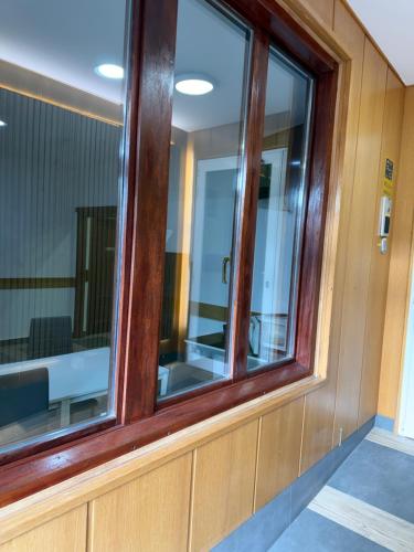 a window in a room with a wooden wall at Pensión La Salve in Bilbao