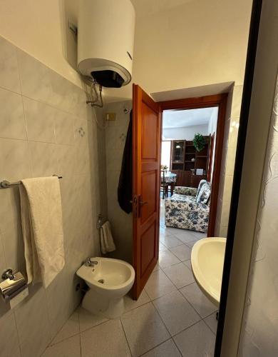 a bathroom with a toilet and a sink at Bastianina's home in Marciana Marina