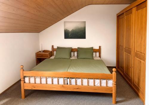 a bedroom with a wooden bed in a room at Falkenstein Loft 55 in Zwiesel