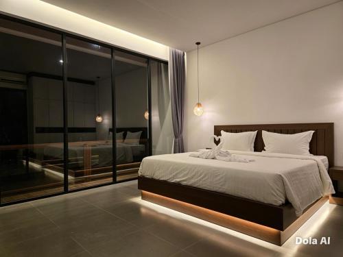 a bedroom with a bed and a view of a bedroom at Hey-Sola Bali ,3BR Luxury Private Villa Near Canggu in Dalung