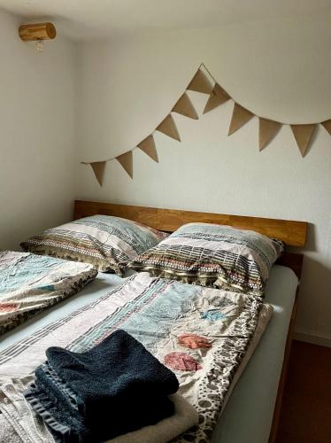 a bedroom with two beds with a headboard and pillows at Ferienwohnung Prignitzhof in Plattenburg