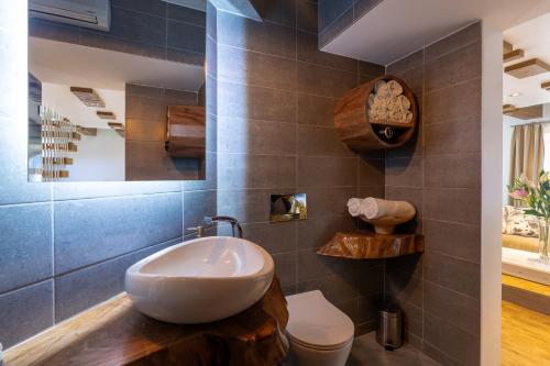 a bathroom with a sink and a toilet at Ali Baba Apartment in Mostar