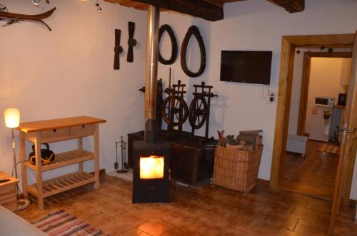 a living room with a wood stove in a room at Drevenička Jakubko in Terchová