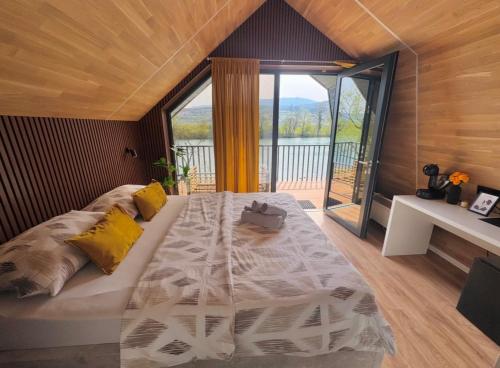 a large bed in a room with a large window at Apartments MLIN in Bihać