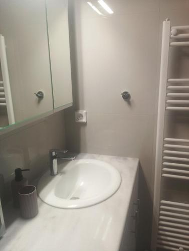 a bathroom with a white sink and a mirror at stavros house byzarkco in Porto Rafti