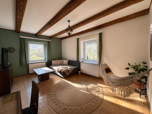 a living room with a couch and a hammock at Rax Panorama Apartment in Arzbach