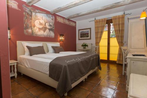 
a hotel room with a large bed and a large window at 4-Sterne Erlebnishotel El Andaluz, Europa-Park Freizeitpark & Erlebnis-Resort in Rust

