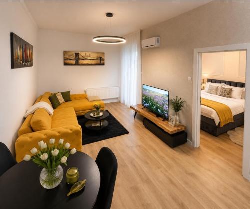 a living room with a couch and a bed at VukAs in Palić