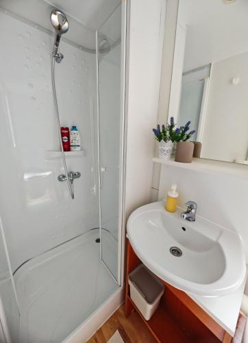 a bathroom with a shower and a sink at Lavender Mobile Houses in Pakoštane