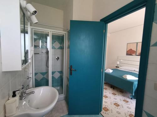 a bathroom with a sink and a shower and a toilet at Villa Rosa Rooms in Ischia Town