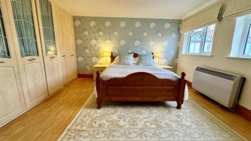 a bedroom with a bed with two pillows on it at The Coach House in Braunton