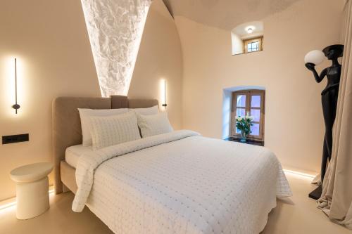 a bedroom with a white bed and a window at Ali Baba Apartment in Mostar