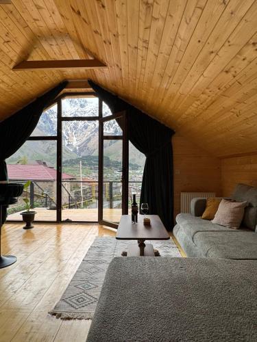 a living room with a couch and a table at Cabin AISI in (( Gergeti ))