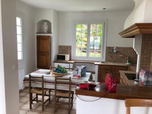 a kitchen with a table with chairs and a sink at Ciboure in Ciboure