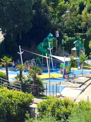 a playground with a water slide in a park at Apartman"Petra" in Krk