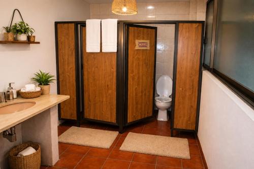 a bathroom with a toilet and a sink at Mariachi House in Mexico City