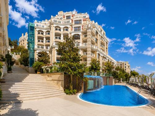a building with a swimming pool in front of a building at Luxurious and panoramic apartments at the beach in La Mer complex in Golden Sands
