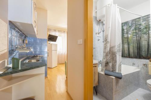 a bathroom with a sink and a toilet and a shower at PINE&SHINE Waterfront in Podgora