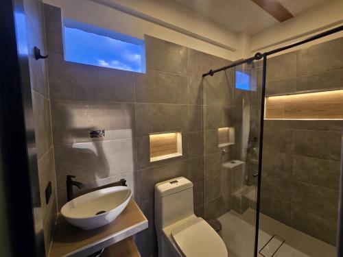 a bathroom with a toilet and a sink and a shower at Villa Yasmin in Prado