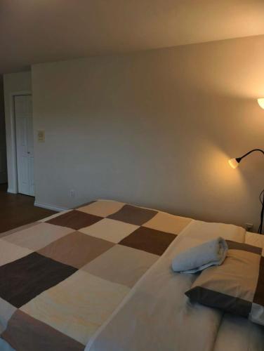 a bedroom with a bed with a pillow on it at Cozy Room With King-sized Bed in Richmond